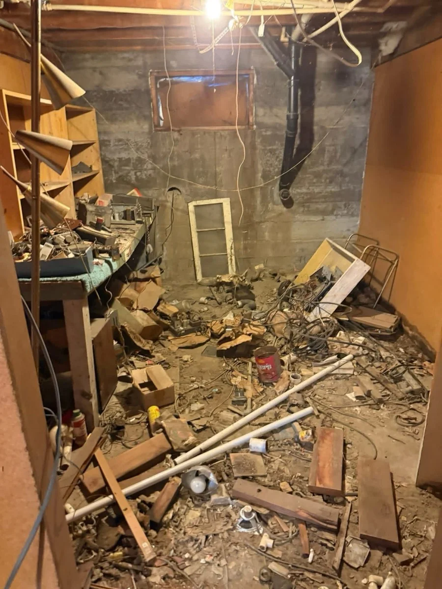 Basement filled with clutter before the cleanout